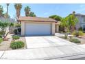 Front exterior featuring a desert landscape and an attached two-car garage at 4916 Carmichael Ave, Las Vegas, NV 89110