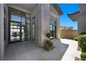 Elegant front entryway with modern stone accents, large windows, and a stylish glass-paneled front door at 5166 Stone View Dr, Las Vegas, NV 89135