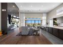 Spacious living room boasts modern fireplace, wood floors, and expansive windows with stunning views at 5166 Stone View Dr, Las Vegas, NV 89135