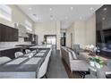 Open concept living features a sleek kitchen, dining area, and modern living room at 5166 Stone View Dr, Las Vegas, NV 89135