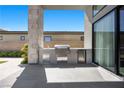 Built-in stainless steel outdoor kitchen with BBQ, mini-fridge, and ample counter space for entertaining at 5166 Stone View Dr, Las Vegas, NV 89135