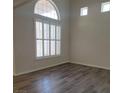 Well lit living room featuring wood flooring and light filtering shutters at 5509 Big Sky Ln, Las Vegas, NV 89149