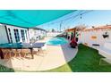 Private backyard oasis boasts a sparkling pool, patio seating, and stylish outdoor decor at 5817 Rae Dr, Las Vegas, NV 89108