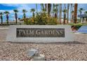 Community sign for Palm Gardens in a community featuring lush palm trees and greenery at 6143 Basilone Ave, Las Vegas, NV 89122