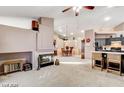 Spacious living room with a cozy fireplace, open floor plan, and seamless flow to the kitchen at 6143 Basilone Ave, Las Vegas, NV 89122