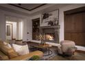 Cozy living room includes built-in shelving, a stone fireplace, and comfortable seating arrangements at 64 Tapadero Ln, Las Vegas, NV 89135