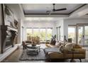 Inviting living room featuring a fireplace, modern decor, and an abundance of natural light at 64 Tapadero Ln, Las Vegas, NV 89135