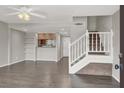 Open-concept living area with wood floors, bookshelves and staircase at 6445 Ironbark Ln, Las Vegas, NV 89107