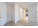 Clean and welcoming entryway with wood floors and neutral walls at 6871 Tamarus St # 204, Las Vegas, NV 89119