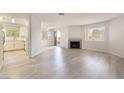 Spacious living room boasts a fireplace, wood floors, and access to a balcony at 6871 Tamarus St # 204, Las Vegas, NV 89119