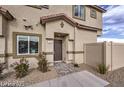 Attractive home exterior featuring manicured landscaping and a welcoming entryway that shows architectural details at 7915 Pandora Sky St # 402, North Las Vegas, NV 89084