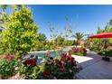 The backyard features a pool and lush landscaping, perfect for outdoor enjoyment at 8221 Bay Dunes St, Las Vegas, NV 89131