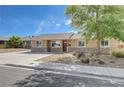 Charming single-story home featuring stone accents, a well-maintained yard, and a long, private driveway at 839 Benita Pl, Boulder City, NV 89005