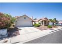 Lovely single-story home with a well-kept front yard, a spacious driveway, and desert landscaping at 8437 Cinnamon Hill Ave, Las Vegas, NV 89129