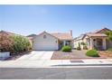 Inviting single-story home featuring a neat front yard, a spacious driveway, and mature landscaping at 8437 Cinnamon Hill Ave, Las Vegas, NV 89129
