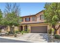 Charming two-story home featuring a well-manicured front yard and two-car garage at 9192 Moose Country Pl, Las Vegas, NV 89178