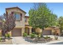 Charming two-story home featuring a well-manicured front yard and two-car garage at 9192 Moose Country Pl, Las Vegas, NV 89178