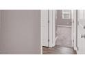 Hallway leading to carpeted bedroom with white trim, showcasing the home's neutral color palette at 9330 Brookmont Ave, Las Vegas, NV 89149