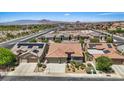 Overhead view of a neighborhood with a desert landscape, tile roofs, and mountain views in the background at 1008 New Creek Ave, Henderson, NV 89015