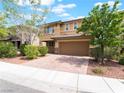 Well maintained two-story house with a two-car garage, manicured landscaping and a sidewalk at 10315 Turia Gardens Rd, Las Vegas, NV 89135