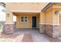 Inviting front porch with stone pillars and a black front door at 10315 Turia Gardens Rd, Las Vegas, NV 89135