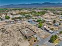 Expansive aerial view showcases the home's location within a tranquil desert community and mountain views at 1190 W Sierra Vista Cir, Pahrump, NV 89060
