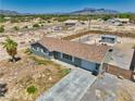 An aerial view of the home showing the outbuilding, desert landscape and ample parking space at 1190 W Sierra Vista Cir, Pahrump, NV 89060