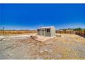 A charming outbuilding featuring a brick patio, windows, and a secure fenced yard for privacy at 1190 W Sierra Vista Cir, Pahrump, NV 89060