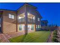 Backyard view with patio, grass lawn, sliding doors and second story balcony at 12367 Aster Hills Ave, Las Vegas, NV 89138