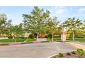 Attractive home exterior with a well-maintained lawn, mature trees, and colorful landscaping at 1383 Opal Valley St, Henderson, NV 89052