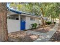 Exterior shot of a quaint home with a blue accent door and a neat, landscaped yard at 2028 Bavington Dr # A, Las Vegas, NV 89108