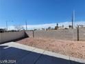 Spacious backyard featuring a concrete patio and low-maintenance desert landscaping at 2711 Morning Break Ct, Las Vegas, NV 89142