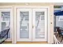 White double doors leading to an outdoor patio area with seating and a blue umbrella at 2749 Lodestone Dr, Las Vegas, NV 89117