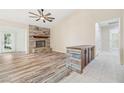 Spacious living room with a stone fireplace, wood-style flooring, and an open layout for versatile living at 2836 Linkview Dr, Las Vegas, NV 89134