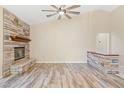 Bright living room featuring a stone fireplace, wood flooring, and neutral tones for a comfortable atmosphere at 2836 Linkview Dr, Las Vegas, NV 89134