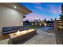 Backyard view showcasing the linear fire pit and patio seating, great for outdoor lounging at 4050 N Tomsik St, Las Vegas, NV 89129