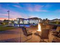 Expansive backyard with a pool, lounge chairs and fire pit for evening relaxation at 4050 N Tomsik St, Las Vegas, NV 89129