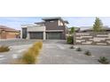 Contemporary home's front exterior featuring a desert landscape and modern architectural design at 4050 N Tomsik St, Las Vegas, NV 89129