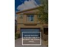 Inviting two-story home featuring a blue garage door and desert landscaping at 4512 Moon Hill Rock Ave, North Las Vegas, NV 89084