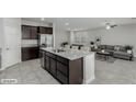 Modern kitchen with island, granite countertops, and open to living area at 4512 Moon Hill Rock Ave, North Las Vegas, NV 89084