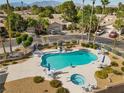 Community pool with lounge chairs, umbrellas, and a jacuzzi, perfect for relaxation and recreation at 4909 Ocean Shores Way, Las Vegas, NV 89130