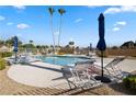 Lounge chairs surround a community pool with tall palm trees at 4909 Ocean Shores Way, Las Vegas, NV 89130