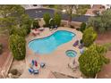 Resort style community pool and spa with lounge chairs and mature trees at 4909 Ocean Shores Way, Las Vegas, NV 89130
