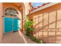 Stylish home entrance with double turquoise doors, elegant archway, and manicured plants enhancing curb appeal at 5350 Sharon Marie Ct, Las Vegas, NV 89118