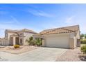 Inviting home with desert landscaping, a wide driveway, and a two-car garage, showcasing curb appeal at 538 Ancient Mayan Dr, Henderson, NV 89015