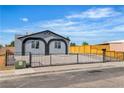 Charming home featuring a secure fence, desert landscaping, and unique window accents at 5580 Waltham Ln, Las Vegas, NV 89122