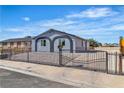Charming home featuring a secure fence, desert landscaping, and unique window accents at 5580 Waltham Ln, Las Vegas, NV 89122