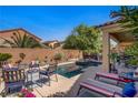 Relaxing backyard oasis with a private pool, lounge chairs, and a covered patio perfect for entertaining at 6440 Bristlebird St, North Las Vegas, NV 89084