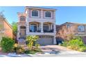 Inviting two-story home with a charming balcony, brick driveway, and lush landscaping at 6714 Flamenco Ct, Las Vegas, NV 89139