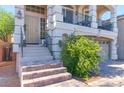 Welcoming front entrance with a stylish door, tiled steps, and manicured greenery at 6714 Flamenco Ct, Las Vegas, NV 89139
